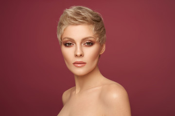 Portrait of sexy blonde woman with short hairstyle looking at camera