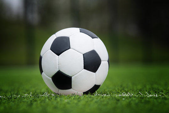 Closeup soccer ball in green grass on stadium