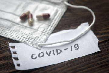 COVID-19, medical mask and pill capsules for treatment coronavirus. Novel corona virus pandemic and...