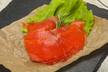 Sliced salmon fillet served rosemary