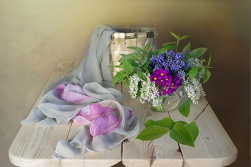 Spring flowers in the basket.Pink Badan on white background .