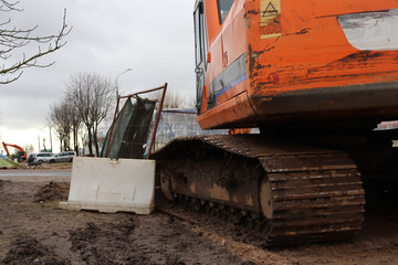 Excavator at a construction site. Orange digger
