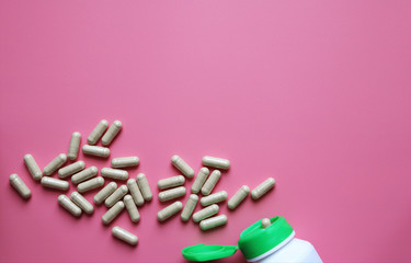 capsules pills on a pink background, vitamins