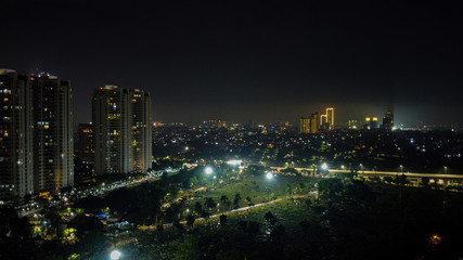 Obraz premium Modern buildings of Jakarta with lights at night on background, view from Kuningan Jakarta, Indonesia