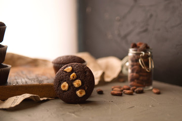 Chocolate muffins with nuts on a wooden table. delicious sweet dessert. rustic style.