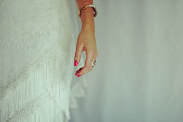 Mano de una novia  el día de su boda con joyas y uñas pintadas 