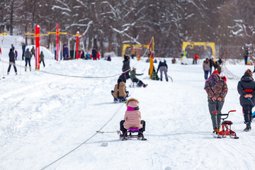 Skiers skiing climb a yoke on a mountain. Light skiing track in Bakuriani