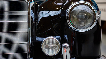 Detail of classic car. Close-up of headlight.