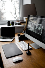Stylish workspace with laptop on home or studio. photographer's workplace