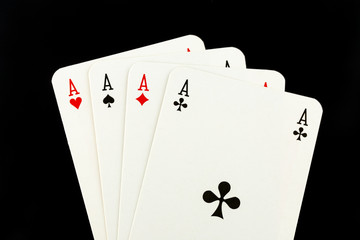 Four aces on black background