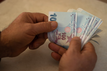 The man is counting Turkish liras, home economy, economic crisis in Turkey, Turkish currency