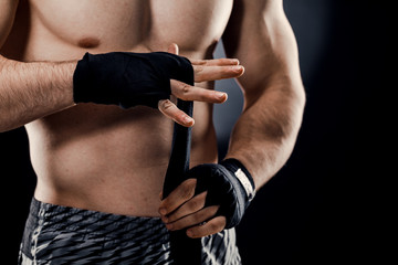 Close-up of a male boxer's hand with Boxing bandages. Fists of a fighter before a fight or training...