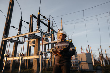 The energy engineer inspects the equipment of the substation. Power engineering. Industry