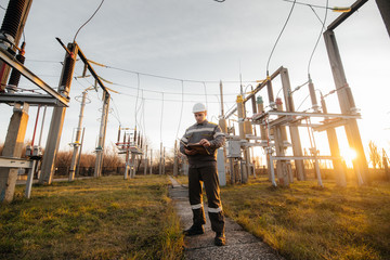 The energy engineer inspects the equipment of the substation. Power engineering. Industry