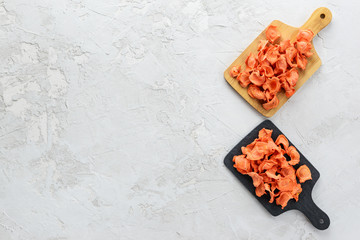 Obraz na płótnie Canvas Carrot chips on the boards on a gray background. Horizontal orientation, top view, copy space.