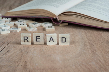 word read written with cube letters on wooden background