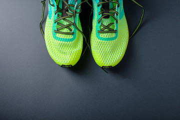 Yellow running shoes, blue dumbbells top view