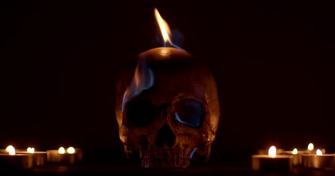 Burning human skull closeup footage