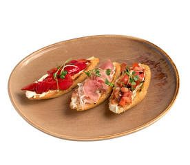 Brushetta set for wine Variety of small sandwiches appetizer on white plate isolated on white background side view