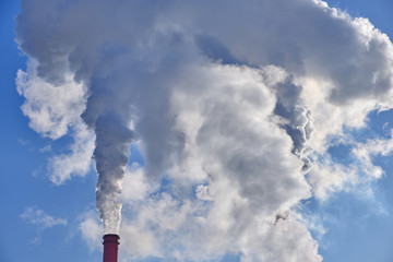 Factory chimney against blue sky