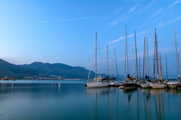 View of sailing yachts in the Mediterranean in beautiful evening light, a summer cruise. Gaeta, Italy.