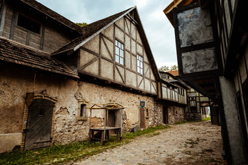 Old traditional vintage timber building facade with windows in old village