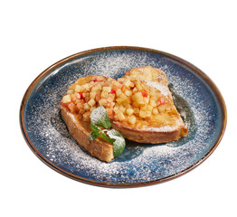 Hot french toasts with caramelized apples for breakfast. Closeup, isolated on white background side...