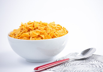 Natural corn flake breakfast cereal in cups and milk is a healthy breakfast that is good for your body every day on a white background.