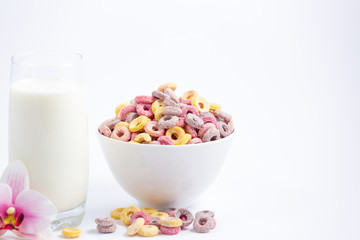 Corn cereal breakfast flake in children cups and milk is a healthy breakfast that is good for your body every day on a white background.