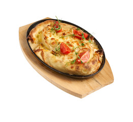 Vertuta - dough with cheese in a pan. Tasty and delicate pastries of Moldavian and Ukrainian cuisine. Side view of selective focus on a white background