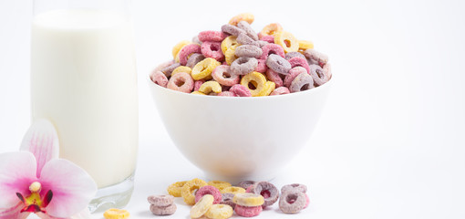 Fototapeta na wymiar Corn cereal breakfast flake in children cups and milk is a healthy breakfast that is good for your body every day on a white background.