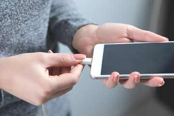 woman hand phone with USB cabel