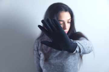 woman hand black gloves stop sign
