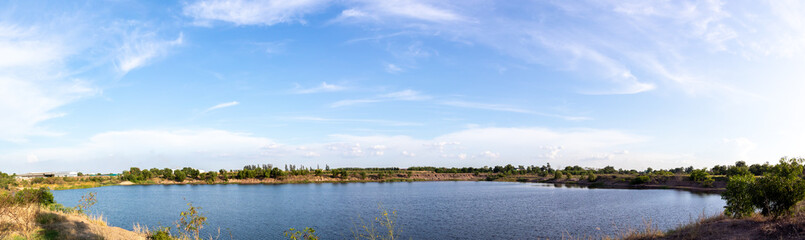 Fototapeta na wymiar Panorama of blue sky with clouds, Sky background image, Natural pool at bottom of picture.