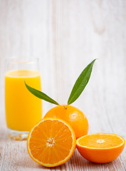 Natural fresh fruit oranges in a wooden background backdrop, half cut oranges, orange juice, vitamin C, for good health everyday