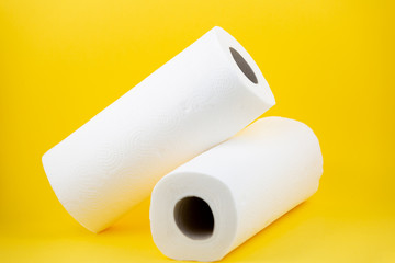 A large white toilet paper roll for use in bathrooms or kitchens, used for cleaning dirt in the bathroom on yellow background