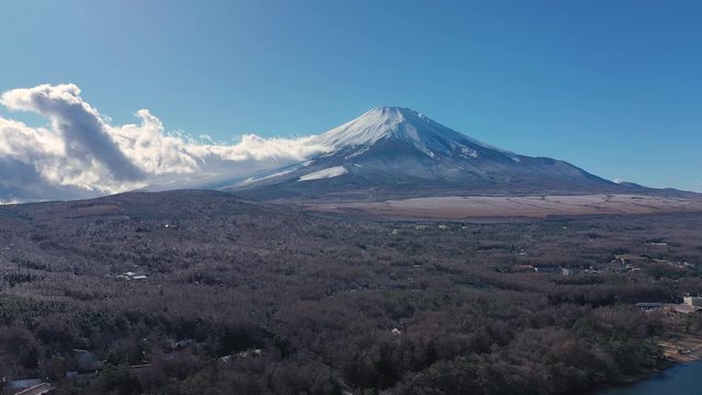 Aerial view of Mount Fuji, iconic snow-capped symbol of Japan, lake Yamanaka, clear blue sky - landscape panorama of Japan from above, Asia