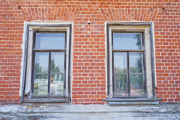 Fototapeta na wymiar The windows of the old palace with a metal mesh for security