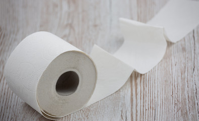 A large white toilet paper roll for use in bathrooms or kitchens, used for cleaning dirt in the bathroom background.