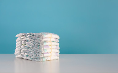 Stack of baby diapers isolated on blue