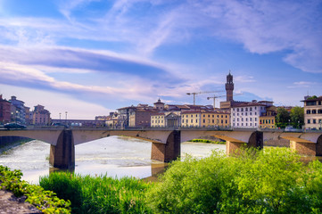 Fototapeta premium A view along the Arno River towards the Ponte Vecchio in Florence, Italy.