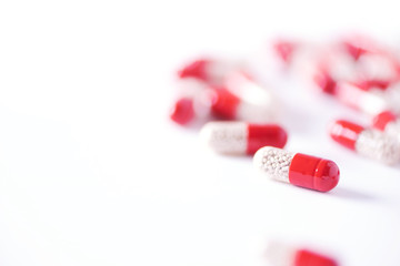 Enzyme capsules on white background. Red pills. Copy space.