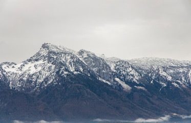 Fototapeta na wymiar winter Alps mountains landscape snowy peak picturesque gorgeous ridge gray cloudy sky background scenic view