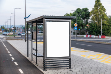 Modern simple bus stop station for passengers in the city street for transportation of people around the town with bench and roof
