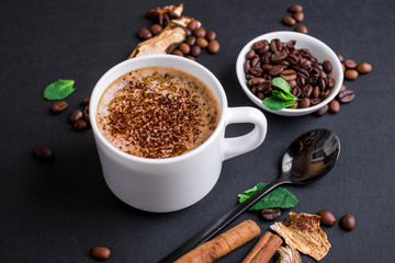 Mushroom Chaga Coffee Superfood Trend-dry and fresh mushrooms and coffee beans on dark background with mint.