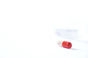 Macro of red capsules on white background. Copy space. Bunch of drugs, cold flu treatment. Coronavirus Covid-19.