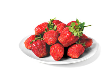 red big strawberries in a white plate on a white background with water drops on berries isolate