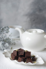 Homemade chocolates with a teapot and a cup of coffee