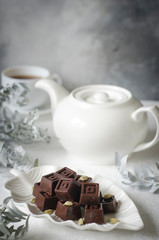 Homemade chocolates with a teapot and a cup of coffee