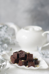 Homemade chocolates with a teapot and a cup of coffee